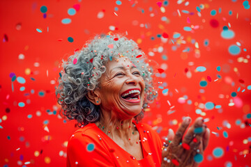 Joyful Elderly Woman Celebrating with Confetti