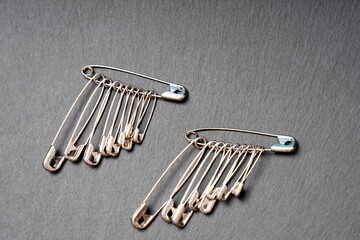 Row of metal safety pins of varying sizes