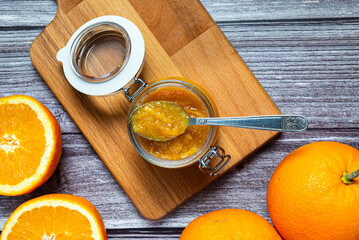 Tasty and healthy homemade orange marmalade. Close-up view of a glass jar with homemade orange marmalade.