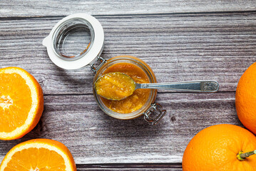 Tasty and healthy homemade orange marmalade. Close-up view of a glass jar with homemade orange marmalade.
