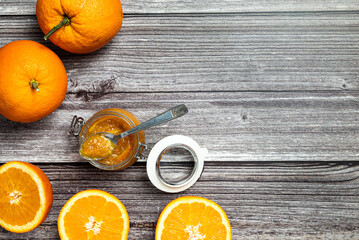 Tasty and healthy homemade orange marmalade. Top view of a table with a jar of homemade orange marmalade.