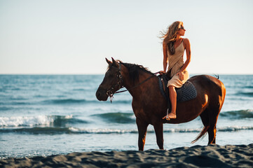 Beautiful woman looking behind her back while taking a romantic horse ride