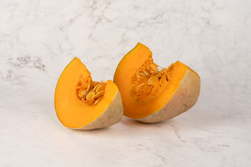 Closeup of two pumpkin slices isolated on a white background