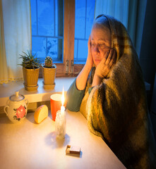 Woman sitting by the window with candles