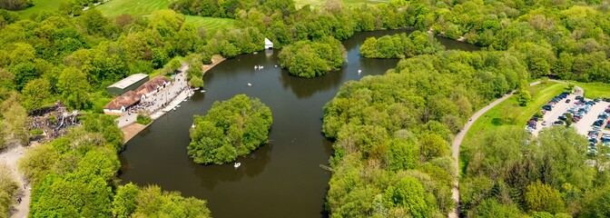 Panoramic aerial image of Heaton Park in Manchester showing boating lake and pedal boats 