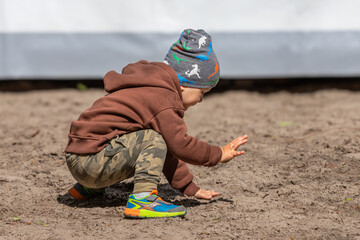 Children of Ukraine. Unknown baby. A boy plays in the sand. Day of protection of children. Raising a child. Memorial Day of children killed by Russian terrorists.
