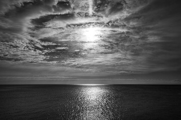 seascape. black and white image of sea sunrise with the sun reflected on the surface