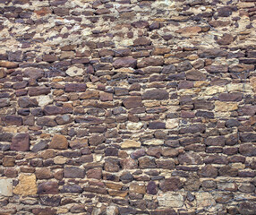 Crumbling old brick and stone wall