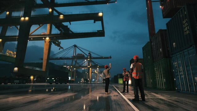 Working in container terminal at the night. Engineers and supervisor at the port