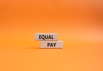 Equal Pay symbol. Wooden blocks with words Equal Pay. Beautiful orange background. Business and...