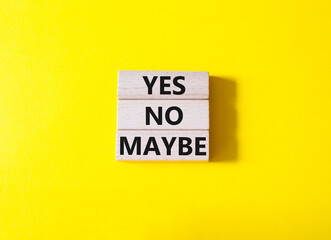 Yes No Maybe symbol. Concept word Yes No Maybe on wooden blocks. Beautiful yellow background. Business and Yes No Maybe concept. Copy space.