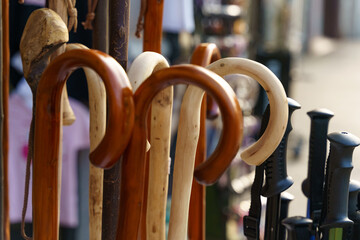 Assortment of Wooden and Plastic Canes on Display at an Outdoor Market Stall