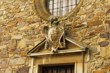 Ornate Stone Carving of Heraldic Crest Above an Ancient Doorway