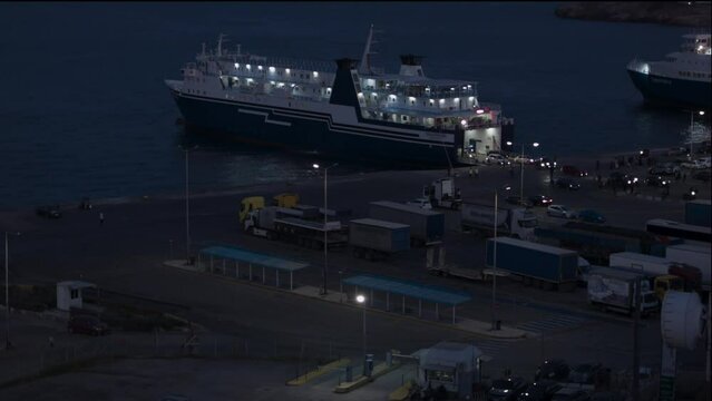 Passengers disembark at Rafina port, Greece, and the ferry departs at night