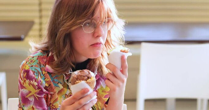 teenage girl with glasses eats ice cream. Psychology of a teenager