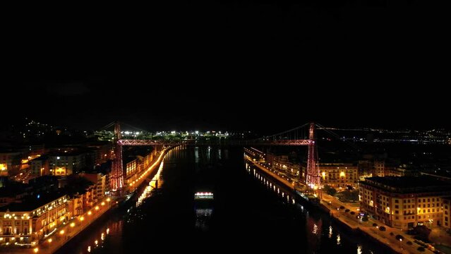 Vizcaya Hanging Bridge (Puente Vizcaya) over Nervion River in Bilbao, Spain, Night Aerial View