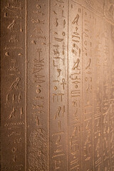 Egyptian hieroglyphs on a stone in a tomb close-up