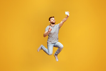 A man is captured mid-jump with a frisbee in hand, showcasing athleticism and fun outdoor activity.