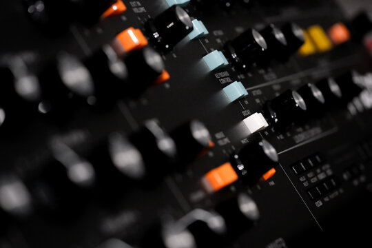 hardware music synthesizer , buttons and knobs of a vintage synth. Musical instrument, recording studio, studio gear, instruments close up, music