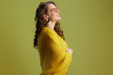 happy fit woman in sweater and glasses against green