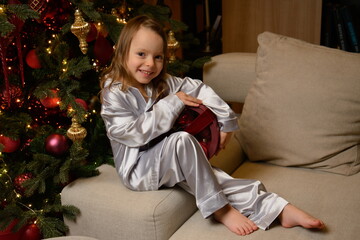 A happy family poses in pajamas in New Year's locations.