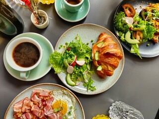Breakfast Plates with Ham and Eggs Croissant on Plates and Coffee