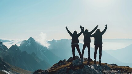 Together overcoming obstacles with three people holding hands up in the air on mountain top. We Made It. Celebrating success and achievements.