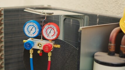 Dolly in close up shot of faulty pressure measurement device used for checking air conditioner...