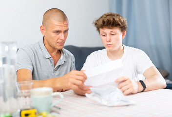 Father and son upset after reading college letter