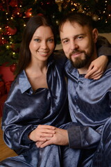 A happy family poses in pajamas in New Year's locations.