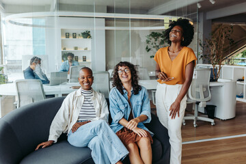 Successful business women laughing happily in a modern office