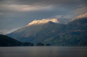 Harrison Lake located in the Fraser Valley of British Columbia with a dusting of snow in the higher elevations. This is a mountain in the Lillooet Ranges of southwestern British Columbia, Canada