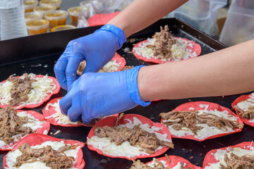 Gloved Hands Preparing Pork Tacos at the Freret Street Festival in New Orleans, LA, USA