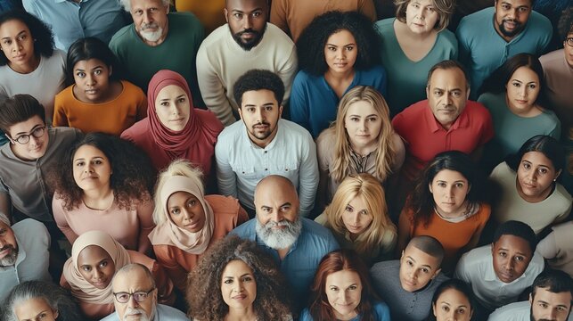 From directly above multi ethnic large group of people looking at camera. Concept of teamwork, democracy, pride, fair.