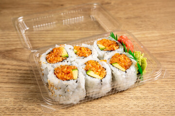 A grocery store plastic takeout package of Spicy Crab Roll sushi