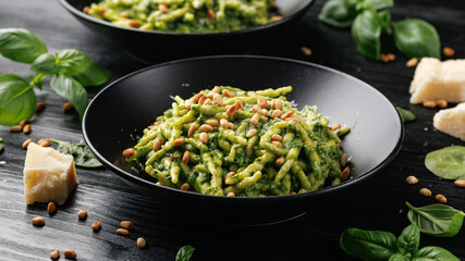 Trofie pasta with creamy spinach sauce and toasted pine nuts