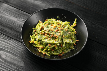 Trofie pasta with creamy spinach sauce and toasted pine nuts