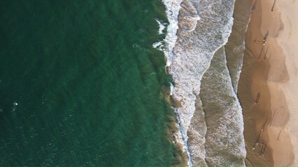 Aerial view of an emerald green sea and big foaming waves. Indian Ocean. Dikwella beach. Sri Lanka....