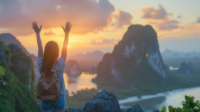 Mental Health concept: Happy girl raised hand on blurred mountain sunrise background.