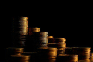 A large variety of coins on a black background. Stack of coins