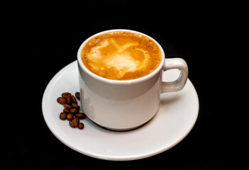 Cup of hot drink with steam over black background