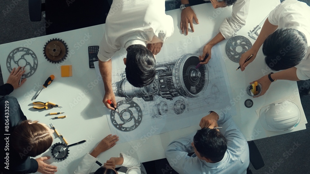Poster top down aerial view of smart engineer team working together to design turbine engine. professional 