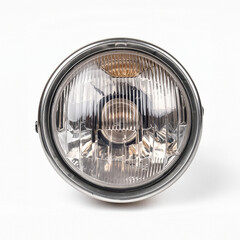A close-up of a round, vintage car headlight