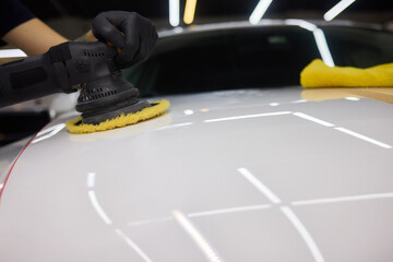 Person using machine to polish cars automotive exterior