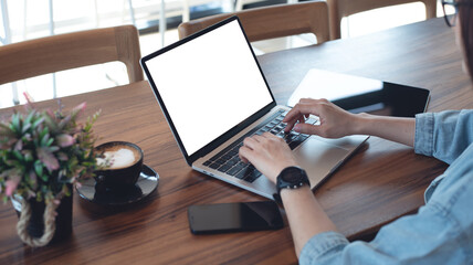 Mockup blank screen laptop computer. Young woman working on laptop with white empty screen,...