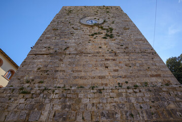 View of the Torre del Candeliere, a medieval tower with clock. Massa Marittima, Grosseto, Tuscany, Italy