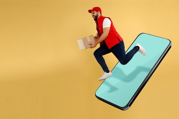 Courier with parcel jumping out from huge smartphone on golden background. Delivery service. Space...