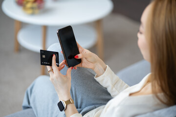 Woman Using Smartphone For Online Shopping, Holding Credit Card, Modern Technology, Secure Payment,...