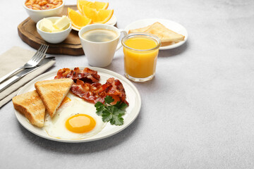 Delicious breakfast with sunny side up egg served on light table. Space for text