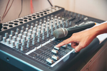 Production sound engineer hands working on recording studio mixing voice control. Expert adjusting...